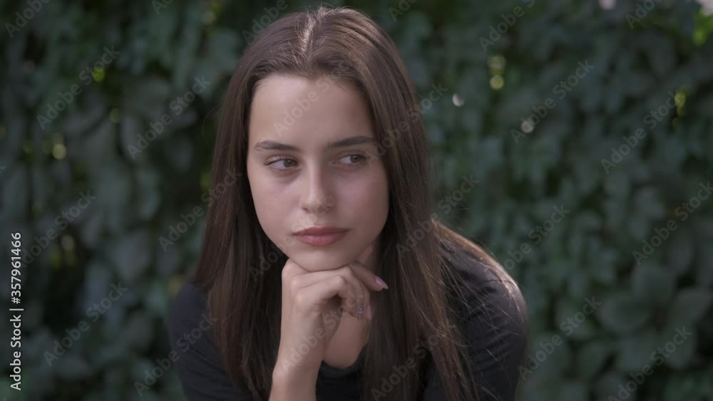 Girl by the green fence. Beautiful young girl outdoors. Girl by the green fence. Beautiful young girl outdoors.