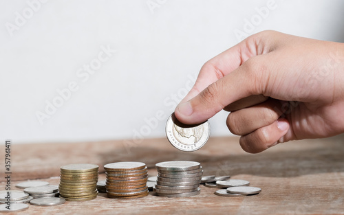 Children hand saving money bokeh background