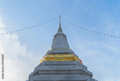 Wat Chantharam Worawihan or Wat Klang Talat Phlu, a Buddhist temple stupa at noon with blue sky in Bangkok city, Thailand. Thai architecture buildings background in travel trip concept. photo