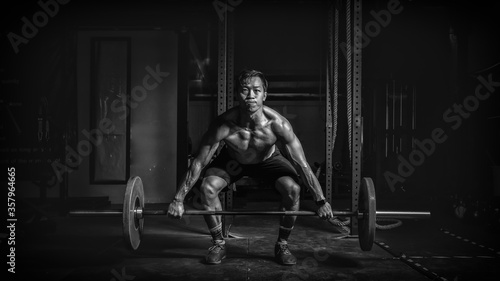 фотографія powerlifter workout with barbell weightlifting in gym and fitness club