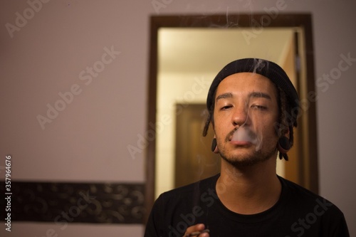 young black man smoking in the house