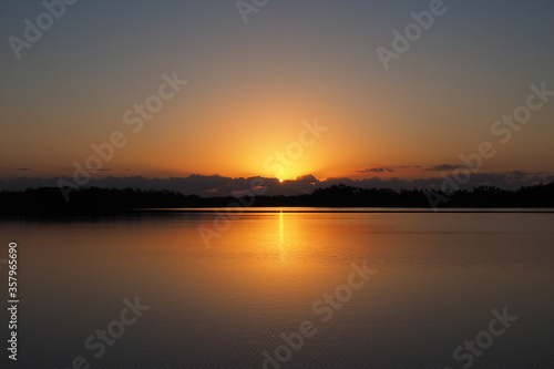 Sunrise over tranquil water of Nine Mile Pond in Everglades National Park, Florida on calm clear morning. © Francisco