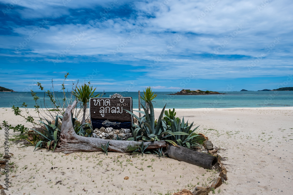 Luklom beach wooden sign board at landmark with white sand blue sea and sky, Samae San island, Sattahip, Chon Buri, Thailand, copy space