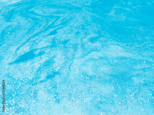 Abstract soap bubbles floating on blue water
