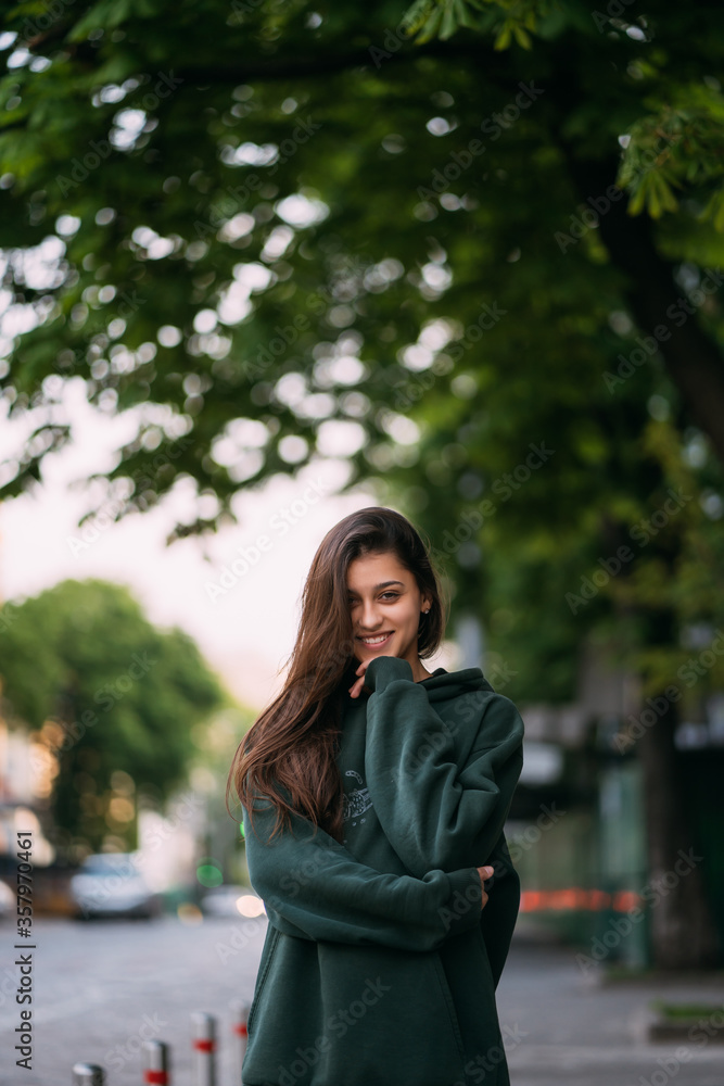 Portrait of cute girl with long hair looks at the camera Portrait of cute girl with long hair looks at the camera