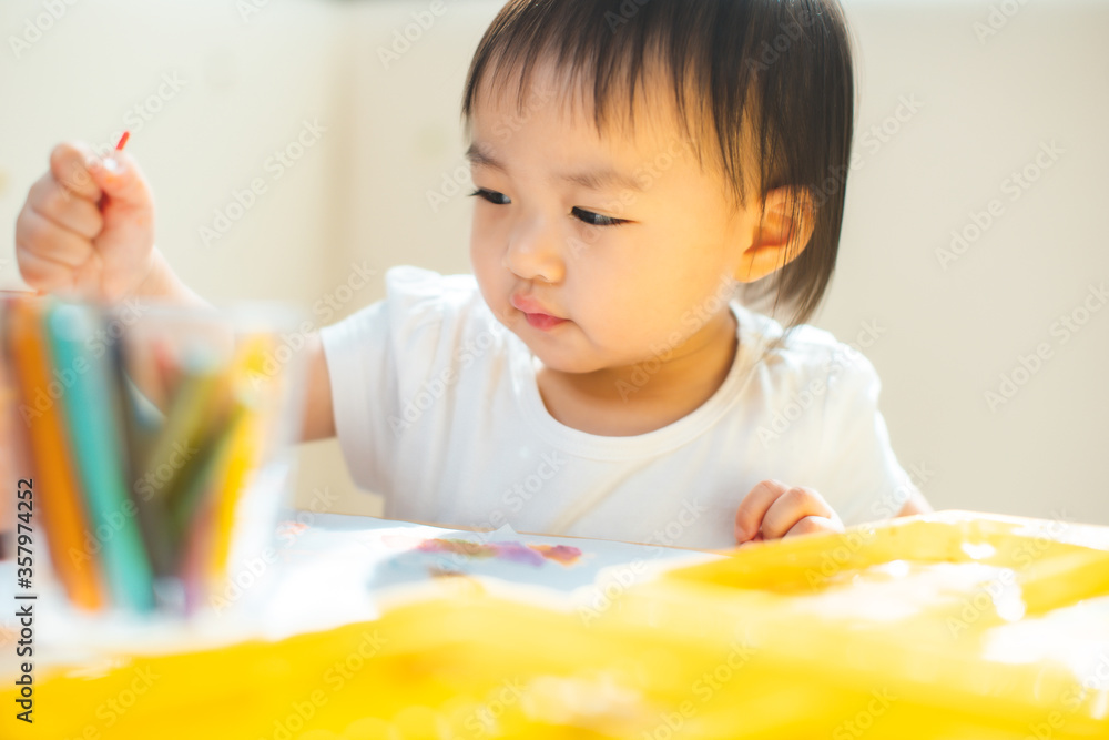 Cute asian little girl is painting the color with fully happiness moment , concept of art and education for kid. closed up kid practice paiting for homeschooling.Lovely asian girl drawing Cute asian little girl is painting the color with fully happiness moment , concept of art and education for kid. closed up kid practice paiting for homeschooling.Lovely asian girl drawing