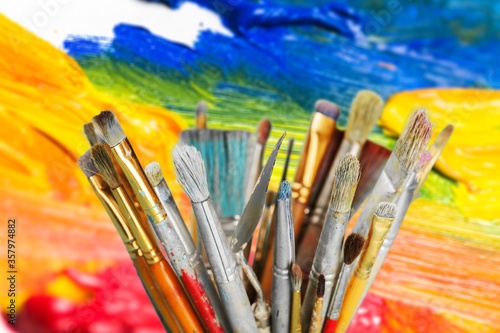 A different set of artist paint brushes on colored background