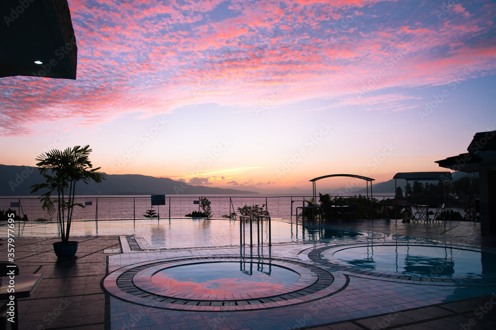 Pink sunset view to lake Toba from the pool