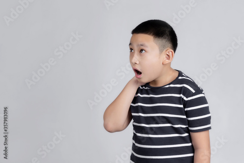 Asian boys studio portrait on gray background with looks shocked