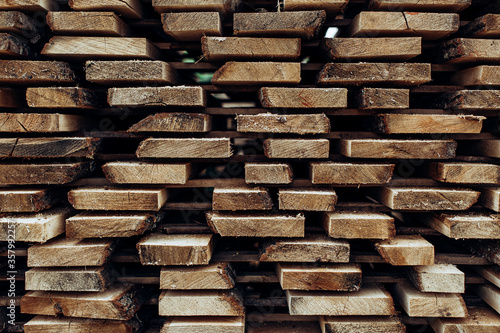 Piles of wooden boards in the sawmill, planking. 