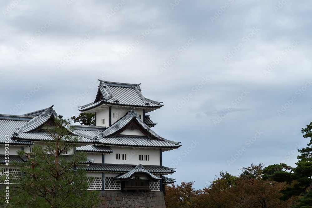 Fototapeta premium Kanazawa Castle with cloudy dark sky background in Kanazawa, Japan, autumn