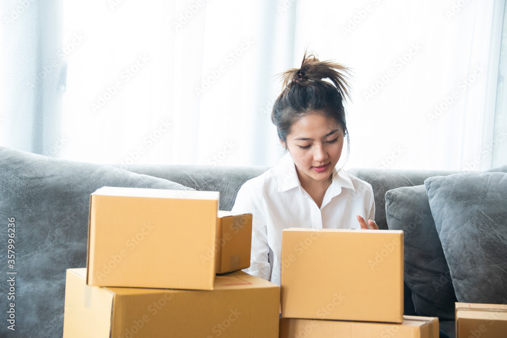 Woman packing and check address customers who order shopping online,work from home and delivery concept for COVID-19 prevention
Woman packing and check address customers who order shopping online,work from home and delivery concept for COVID-19 prevention