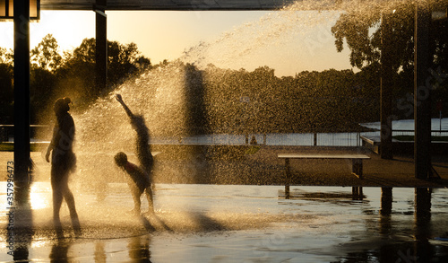 Children playing in a playground water jets in Gladstone, Queensland photo