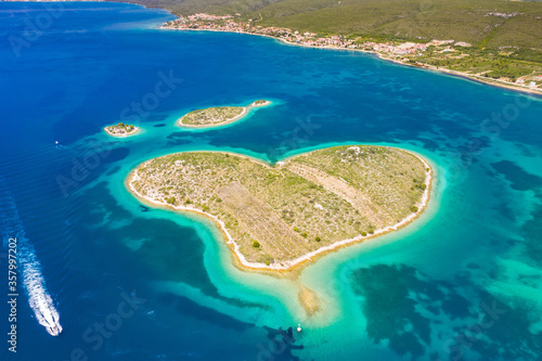 Croatia, beautiful coastline on Adriatic sea, romantic heart shaped island of Galesnjak in turquoise sea in Murter archipelago, aerial view of from drone
