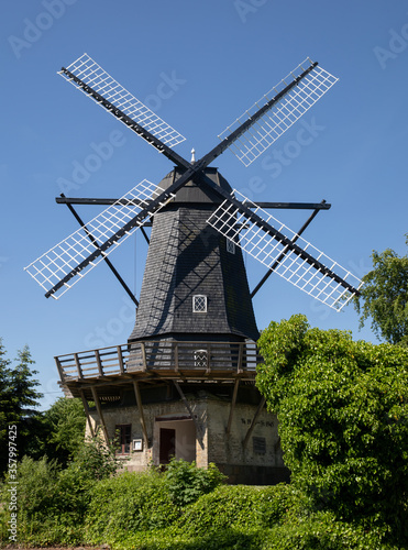 Old black mill with blue sky