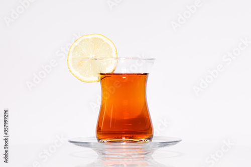 A glass of Turkish tea with lemon isolated on white background. High-resolution photo.