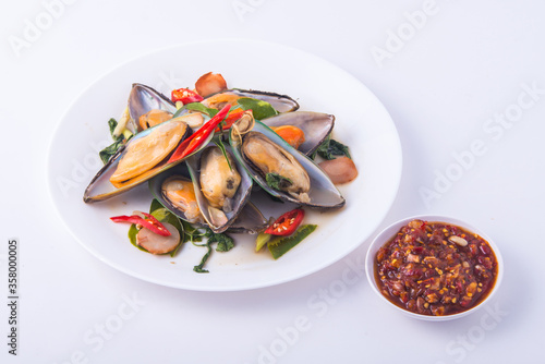 Steamed mussels with herb in the white dish.