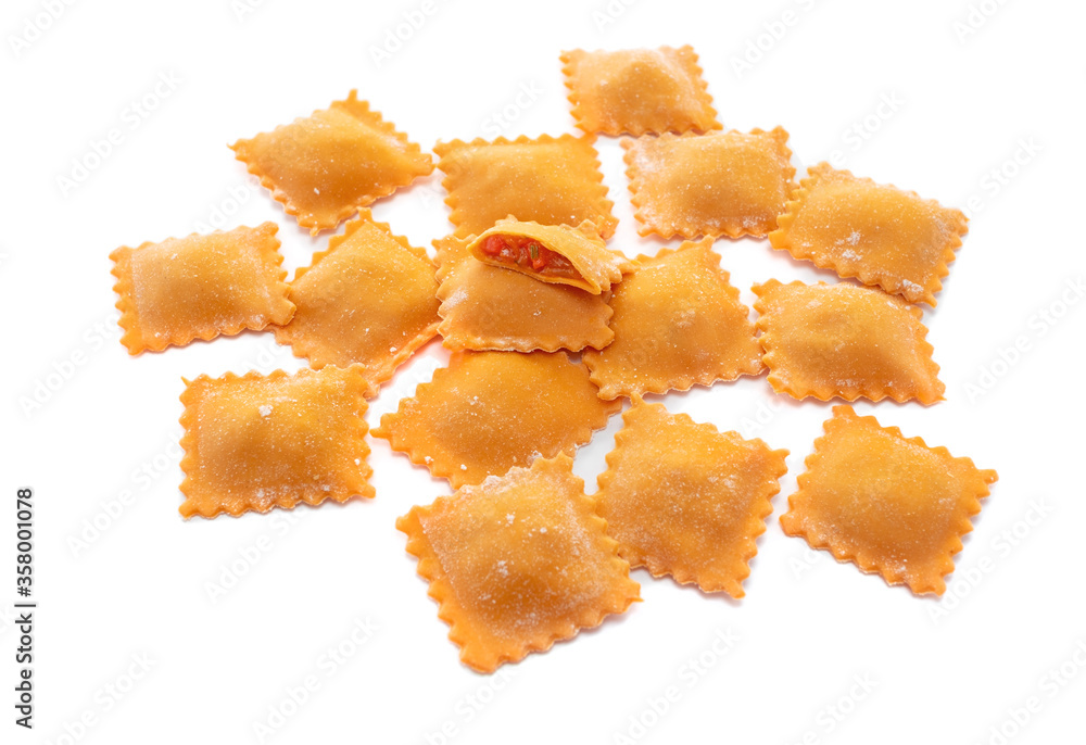 Fresh ravioli pasta colored with paprika isolated on a white background, close up Fresh ravioli pasta colored with paprika isolated on a white background, close up