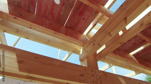 Wooden structures of a house under construction. PAN to right.