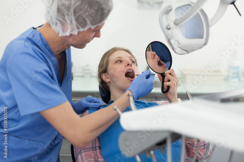 Young woman on dental checkup in modern dentist office