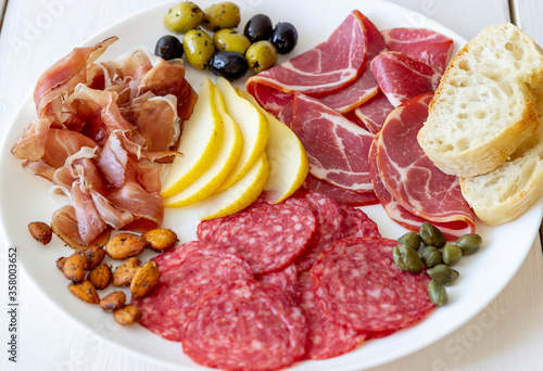 Wine snack. Prosciutto, Parma ham, salami, almonds, olives, baguette, blue cheese, parmesan. Antipasti.