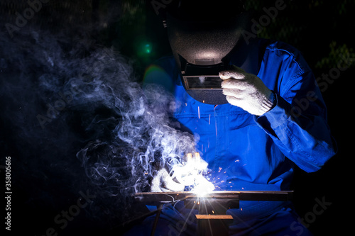 Industry worker mechanic welding iron at industrial factory.