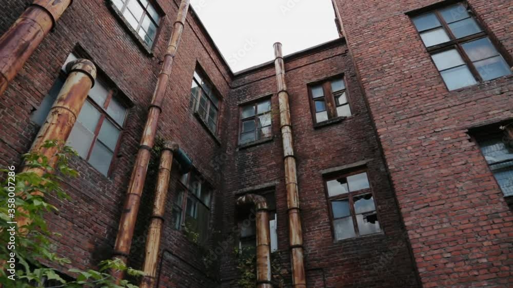 Facade of Abandoned Building. Ruined Walls. Broken Windows. Dead Plant. Destroyed Manufacturing. Bankruptcy and Ruin. Rusty Pipes. Production Capacities will be Demolished. Ghost Building. Crisis Facade of Abandoned Building. Ruined Walls. Broken Windows. Dead Plant. Destroyed Manufacturing. Bankruptcy and Ruin. Rusty Pipes. Production Capacities will be Demolished. Ghost Building. Crisis
