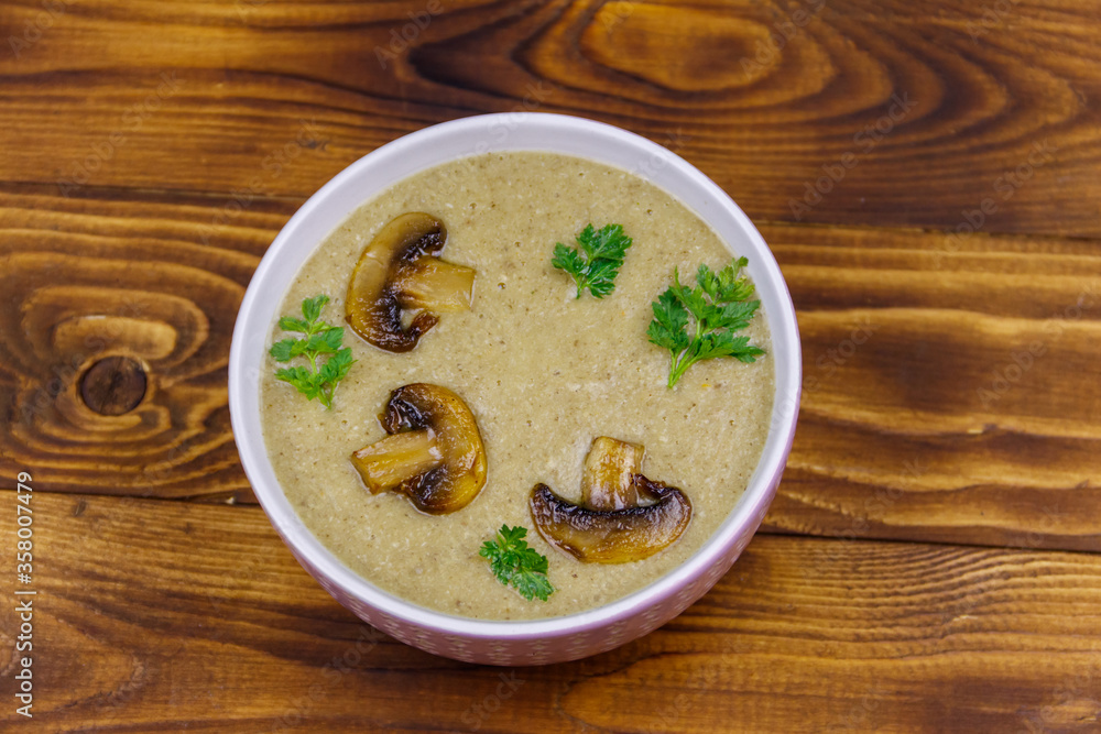 Mushroom cream soup on a wooden table. Top view Mushroom cream soup on a wooden table. Top view