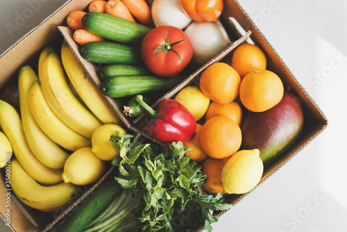 Paper box with fresh fruits and vegetables. Food delivery service. Grocery shopping