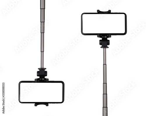 Smartphone with a white cut-out screen on a monopod. Selfie stick and smartphone on a white background. photo