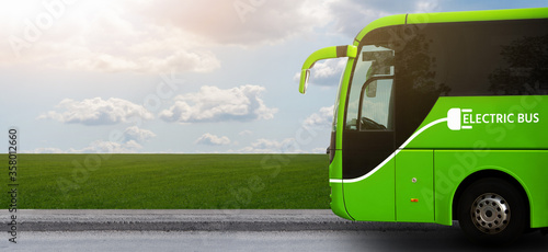 Quadro su tela Electric tourist bus on a background of green field