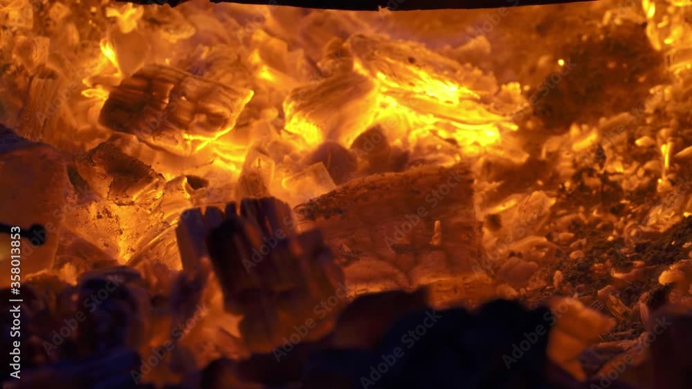 A raging fire in a barrel. burning logs, boards, firewood, pine, in a barrel. bonfire with flying sparks close-up. A raging fire in a barrel. burning logs, boards, firewood, pine, in a barrel. bonfire with flying sparks close-up.