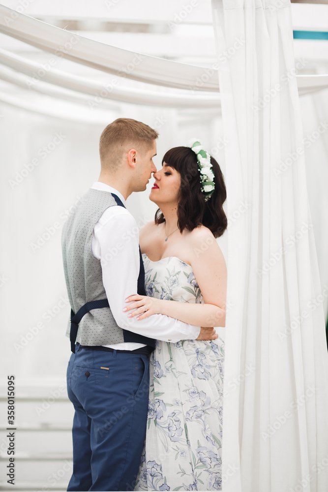 Gorgeous happy couple standing close to each other and looking in eyes Gorgeous happy couple standing close to each other and looking in eyes