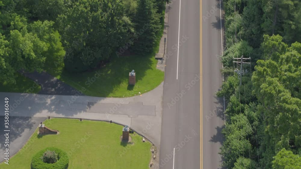 Tilt up road in a nice neighborhood in the summer following a car traveling towards horizon. Tilt up road in a nice neighborhood in the summer following a car traveling towards horizon.