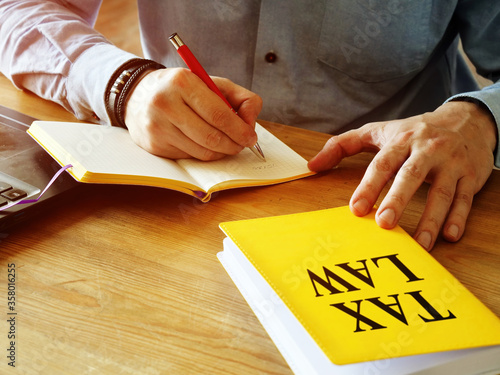 Εκτύπωση καμβά A man counts home finances and holds tax law.