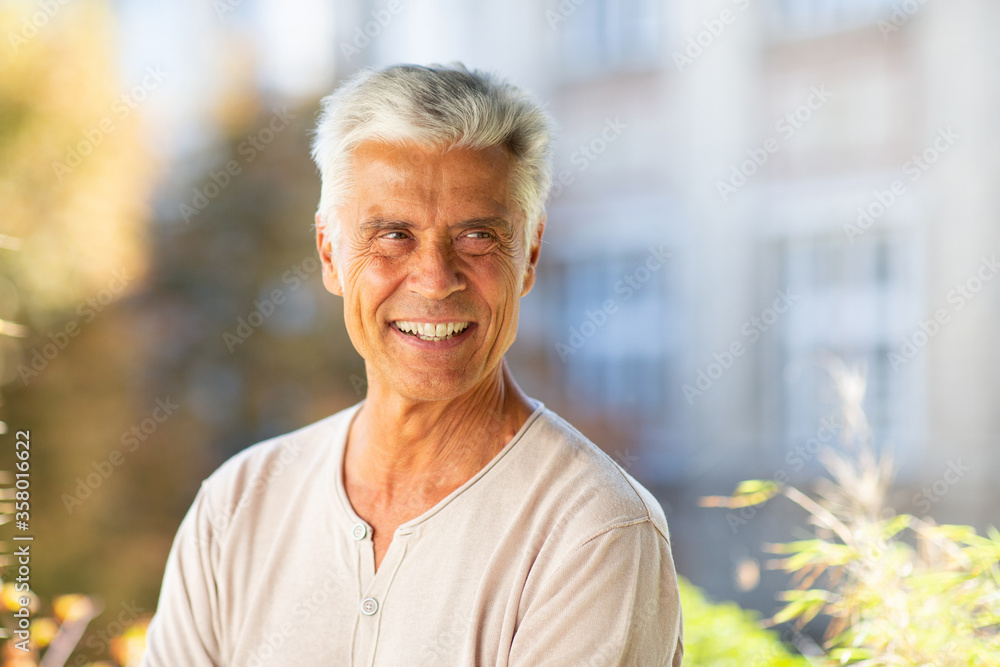 Close up handsome older man smiling outside Close up handsome older man smiling outside