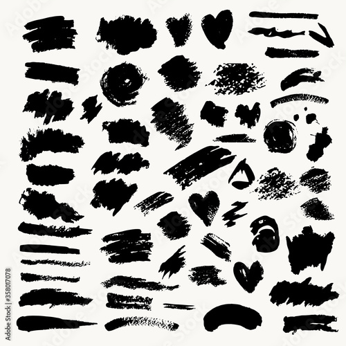 Set of black paint brushes llines and circles on a white background
