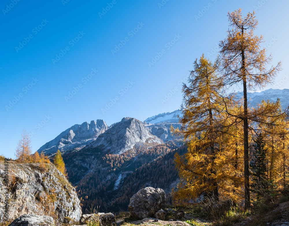 Autumn alpine Dolomites mountain view from Fedaia Pass, Trentino, Sudtirol, Italy. Picturesque traveling, seasonal, and nature beauty concept scene. Autumn alpine Dolomites mountain view from Fedaia Pass, Trentino, Sudtirol, Italy. Picturesque traveling, seasonal, and nature beauty concept scene.