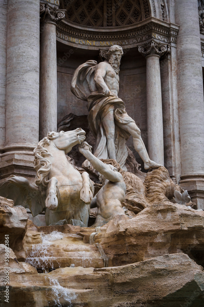 The statue of the god Neptune in the famous Trevi Fountain in Rome
