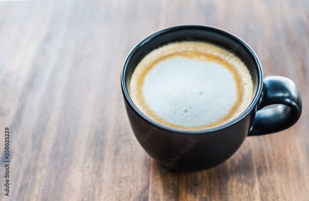 Cup of coffee on brown wooden table at coffee shop. Hot espresso the best start to any morning at cafe with copy space. Cup of coffee on brown wooden table at coffee shop. Hot espresso the best start to any morning at cafe with copy space.