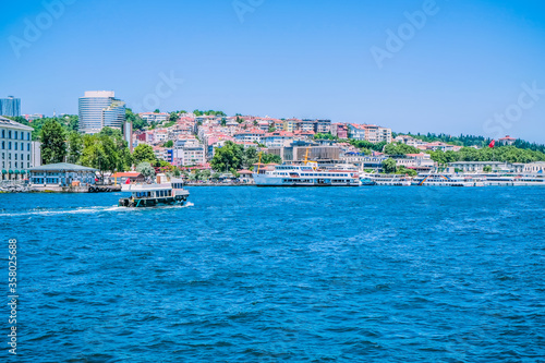 Beautiful scenery port with sightseeing boats in Istanbul background. Resort town side in Bosphorus Bridge, Turkey.