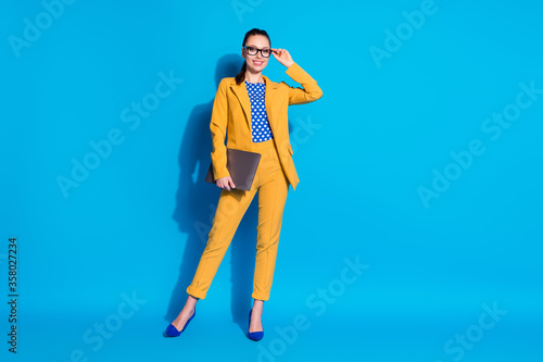 Full length body size view of her she nice-looking attractive classy chic gorgeous lady leader shark touching specs holding in hand laptop isolated bright vivid shine vibrant blue color background