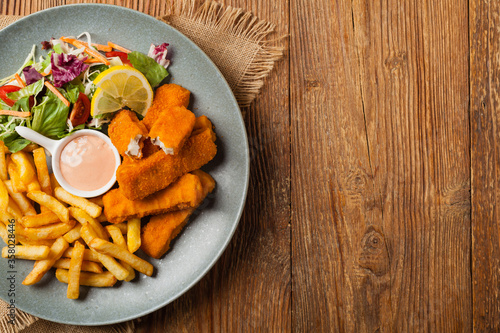 Fish sticks with fries and salad.