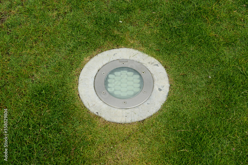 LED Inground Light, Round Inground Uplight,  was mounted on a green lawn.