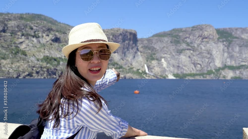 young girl tourist on summer break visit manmade Hetch Hetchy Reservoir in Yosemite National Park provides water to city San Francisco california. happy asian female lean on railing point finger show young girl tourist on summer break visit manmade Hetch Hetchy Reservoir in Yosemite National Park provides water to city San Francisco california. happy asian female lean on railing point finger show
