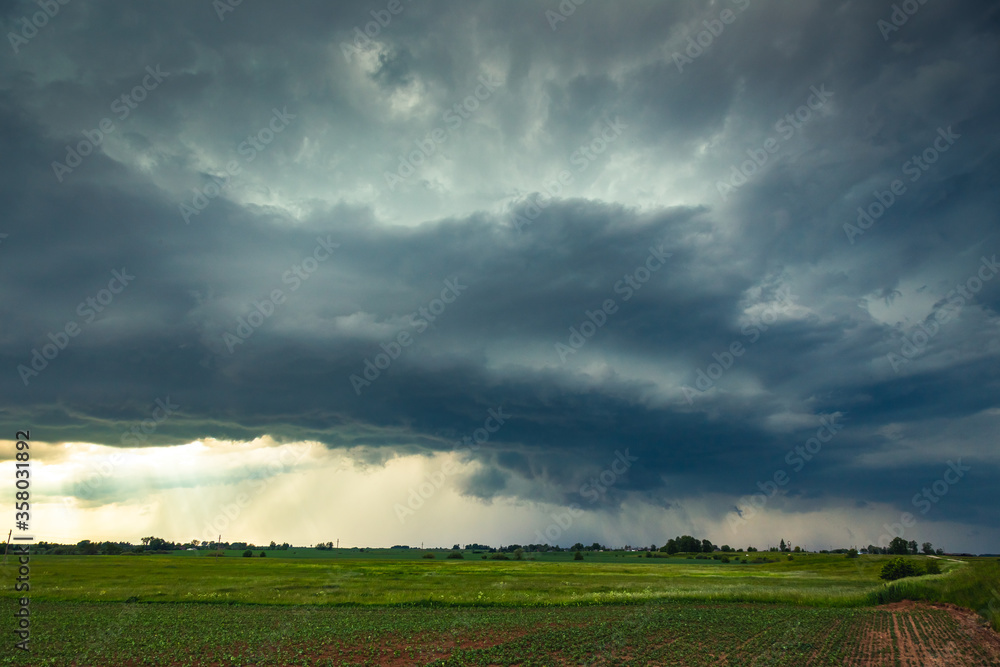 Supercell storm clouds with wall cloud and intense rain Supercell storm clouds with wall cloud and intense rain