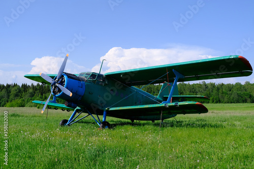 A small airplane is at a small aerodrome.