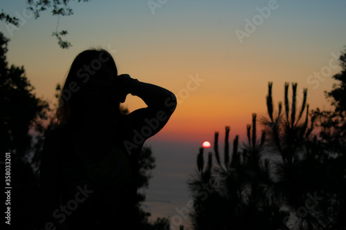 Silhouette of a woman in front of sunset