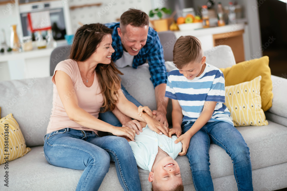 Young family enjoying at home Happy parents with sons having fun. Young family enjoying at home Happy parents with sons having fun.