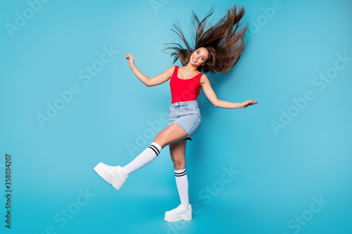 Fototapeta Naklejka Na Ścianę i Meble -  Full size photo charming sweet nice pretty dream girl enjoy spring free time weekend holiday her hairstyle air wind fly throw wear red casual tank-top singlet isolated blue color background